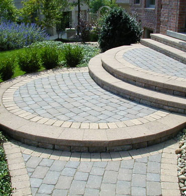 A geometrically pleasing design of patio steps and walkway outside of a residence